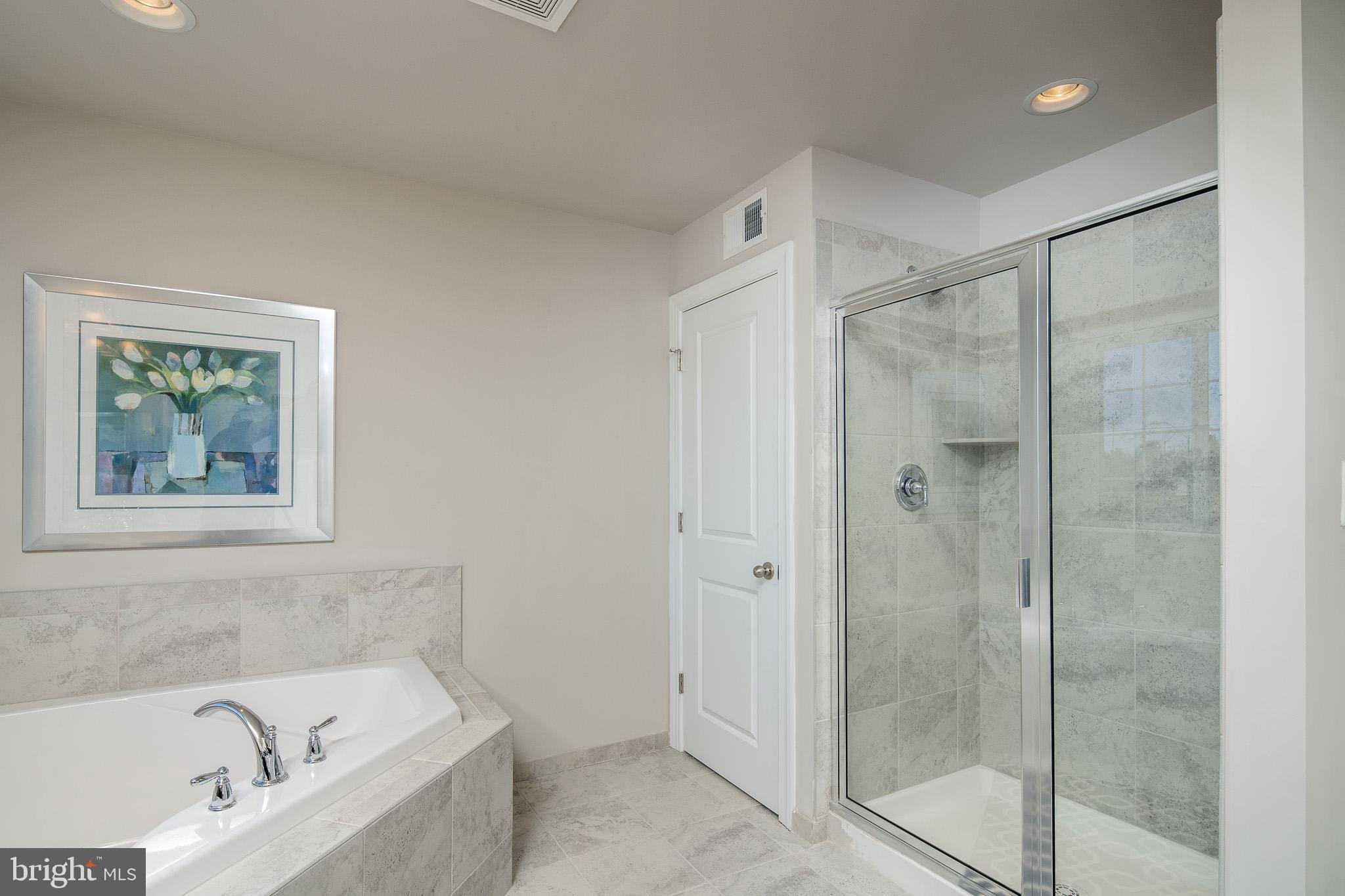 6444 Hanover Road Hanover, MD 21076 - Photo 9 of 29 a bathroom with a bathtub and shower