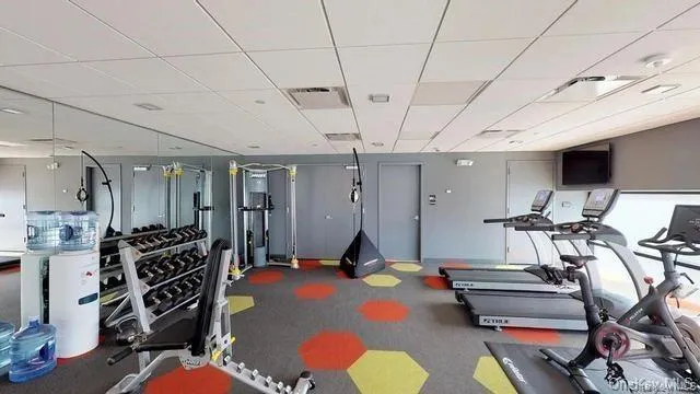a room with gym equipment and view of living room