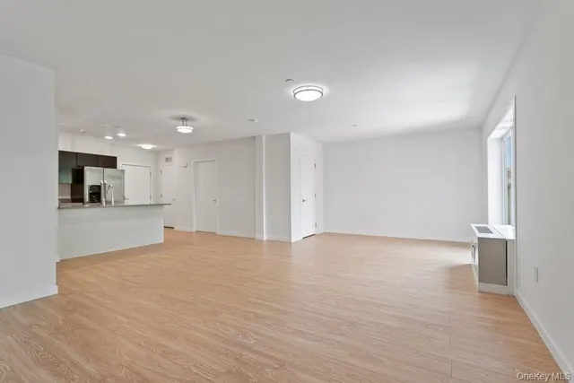 a view of an empty room with a kitchen