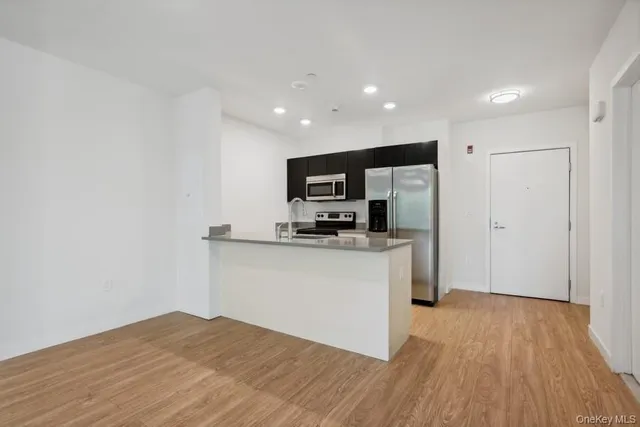 a kitchen with granite countertop a refrigerator and a sink