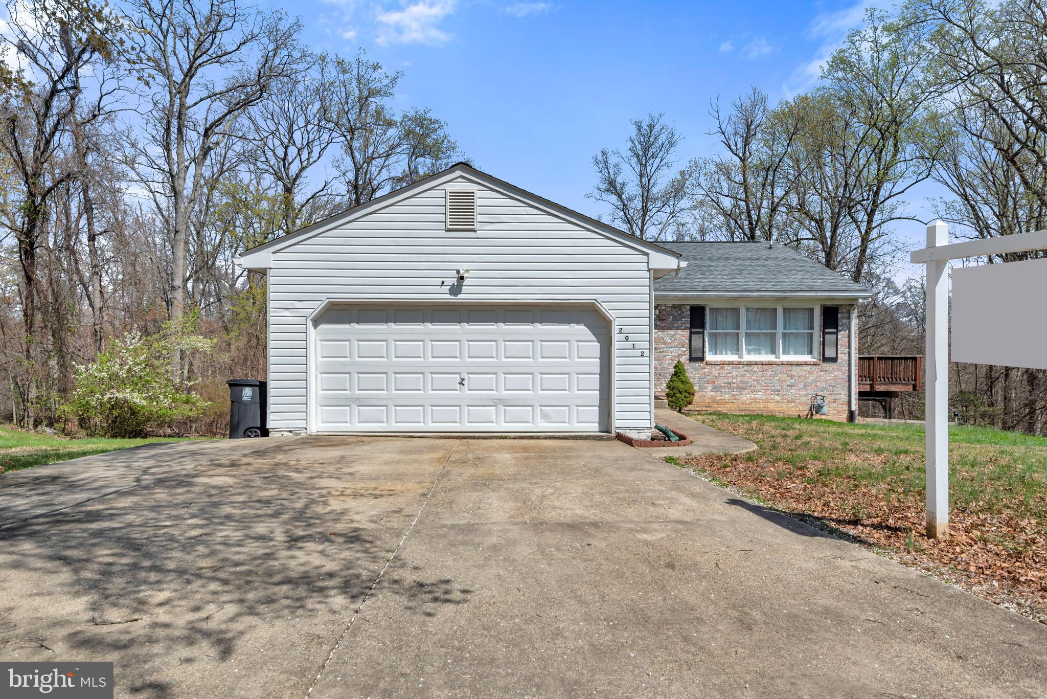 2012 Frontier Court Fort Washington, MD 20744 - Photo 2 of 42 a front view of a house with a yard and garage