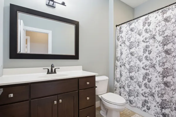 a bathroom with a toilet a sink and a mirror