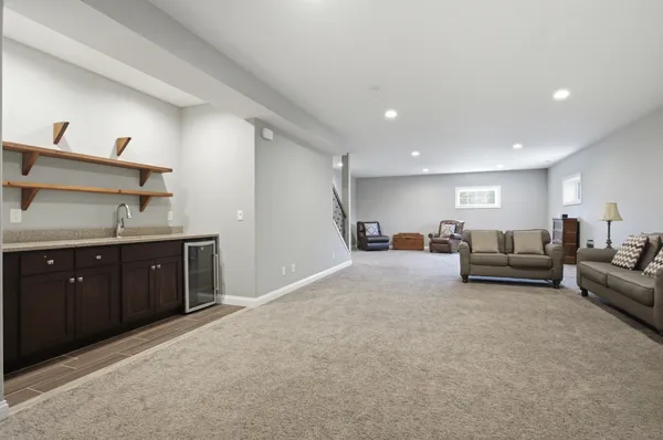 a living room with furniture and a dresser