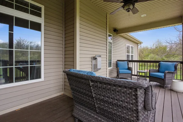a roof deck with couch and chairs