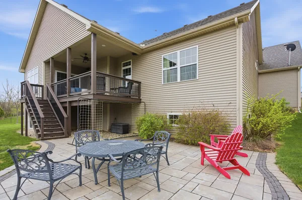a backyard of a house with table and chairs