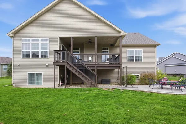 a view of a house with a yard and sitting area