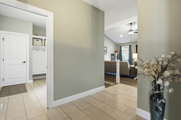a view of a hallway and a livingroom with furniture