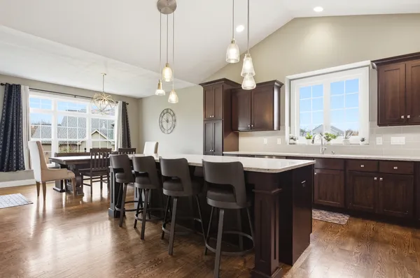 a large kitchen with a table and chairs