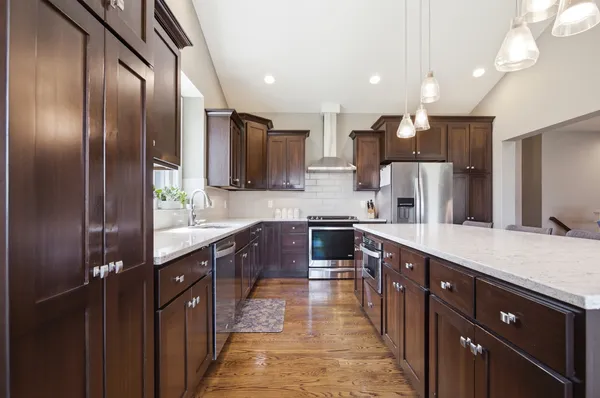 a large kitchen with stainless steel appliances kitchen island granite countertop a large counter top a sink stainless steel appliances and cabinets