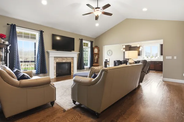 a living room with furniture a flat screen tv and a fireplace