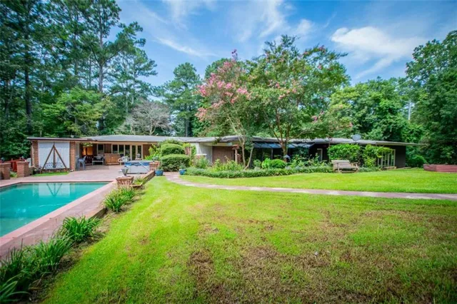 a view of house with outdoor space and garden
