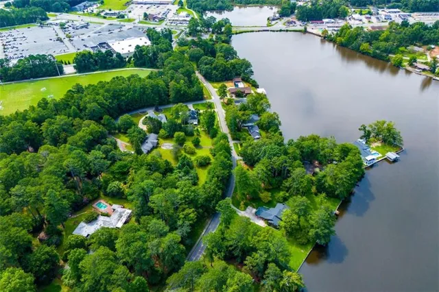 an aerial view of a house with a yard and lake view