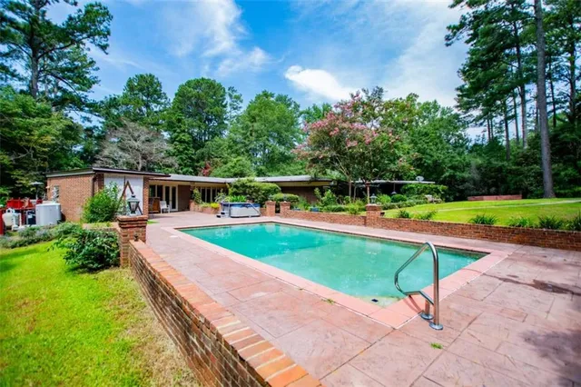 a view of a backyard with swimming pool