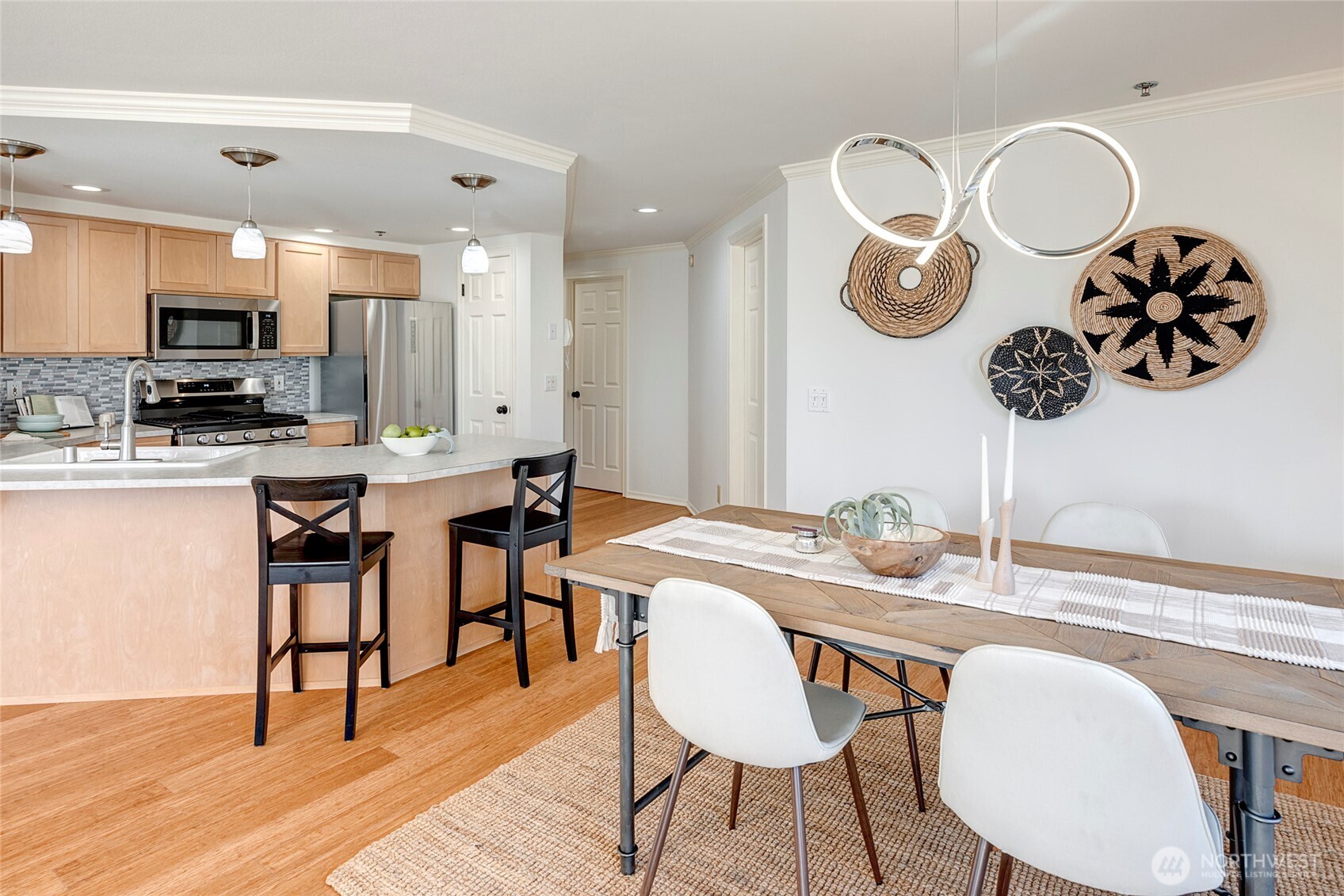 3621 Wallingford Avenue North, Unit 201 Seattle, WA 98103 - Photo 13 of 27 a kitchen with a dining table cabinets and stainless steel appliances