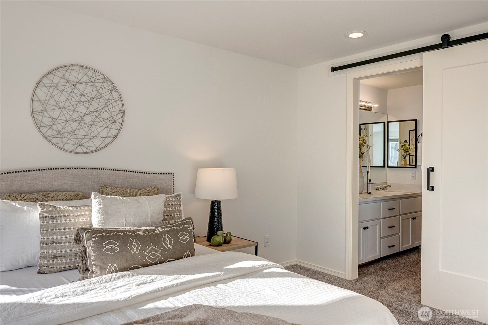 3621 Wallingford Avenue North, Unit 201 Seattle, WA 98103 - Photo 19 of 27 a bedroom with a bed and a mirror