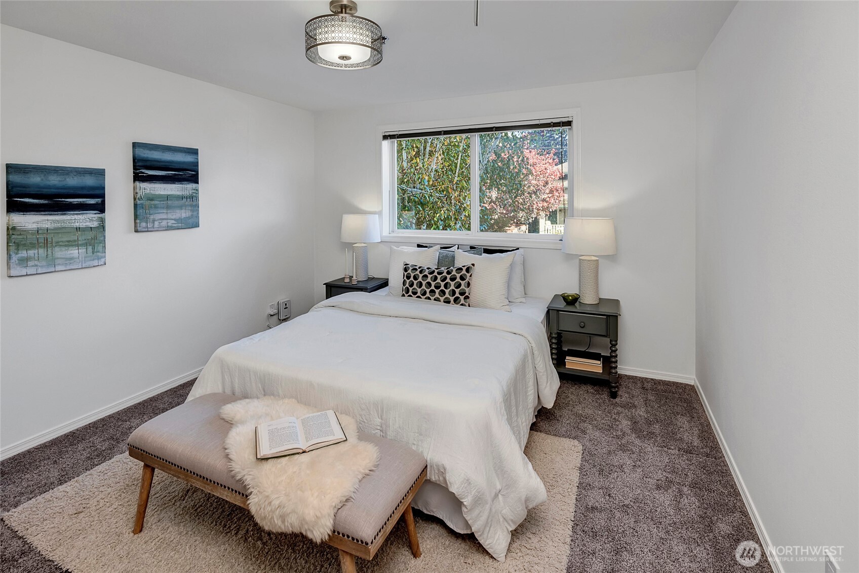 3621 Wallingford Avenue North, Unit 201 Seattle, WA 98103 - Photo 20 of 27 a bedroom with a bed and a window