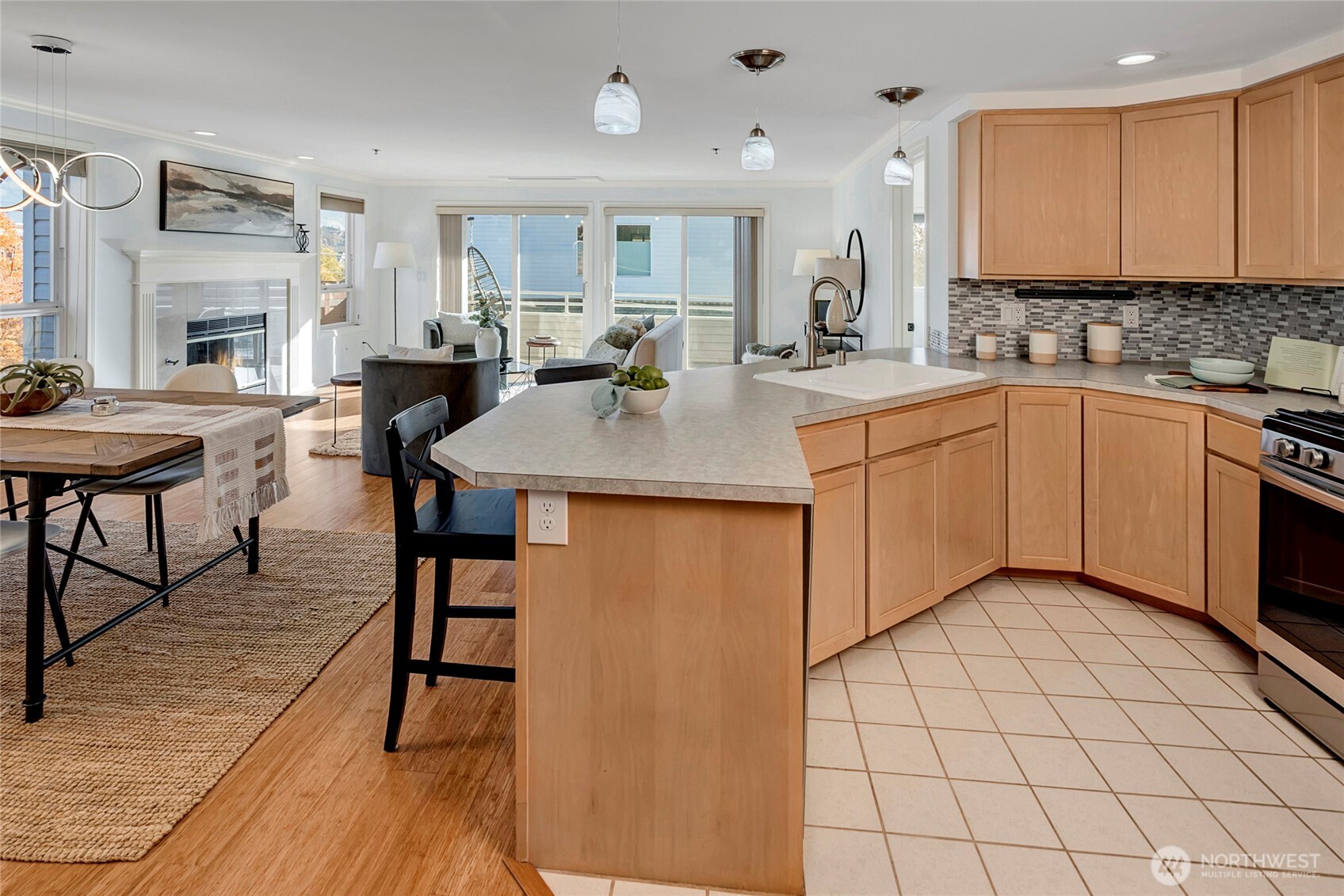 3621 Wallingford Avenue North, Unit 201 Seattle, WA 98103 - Photo 2 of 27 a kitchen with stainless steel appliances granite countertop a table chairs sink and cabinets
