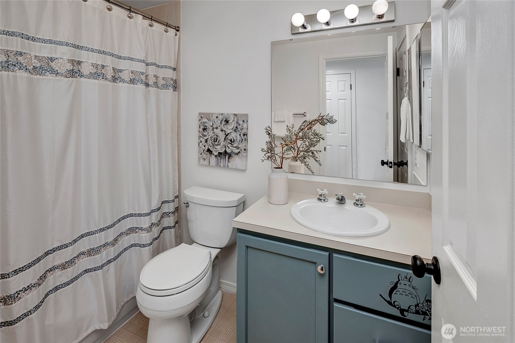 3621 Wallingford Avenue North, Unit 201 Seattle, WA 98103 - Photo 21 of 27 a bathroom with a sink a toilet and shower curtain