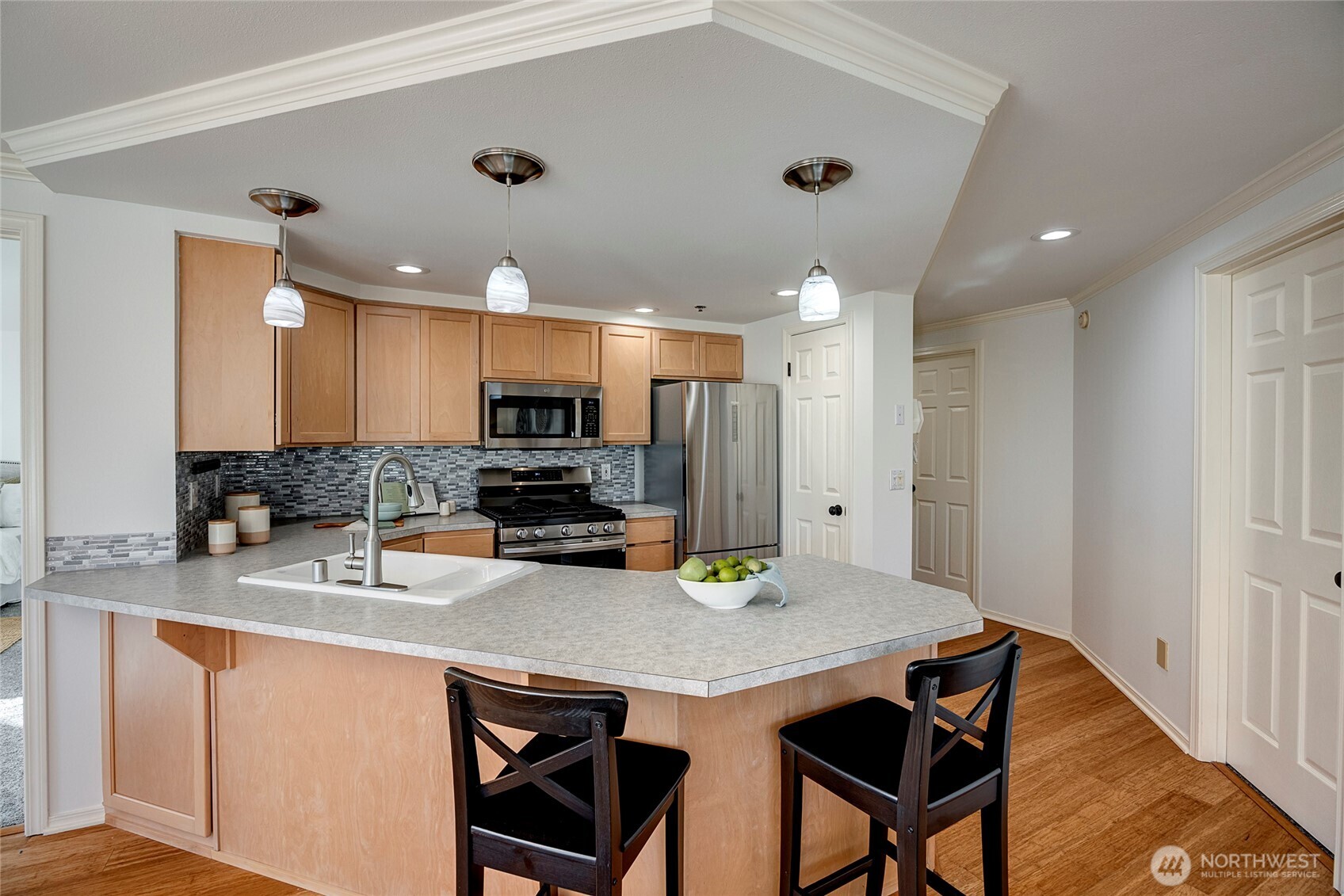 3621 Wallingford Avenue North, Unit 201 Seattle, WA 98103 - Photo 3 of 27 a kitchen with stainless steel appliances granite countertop a sink refrigerator and microwave