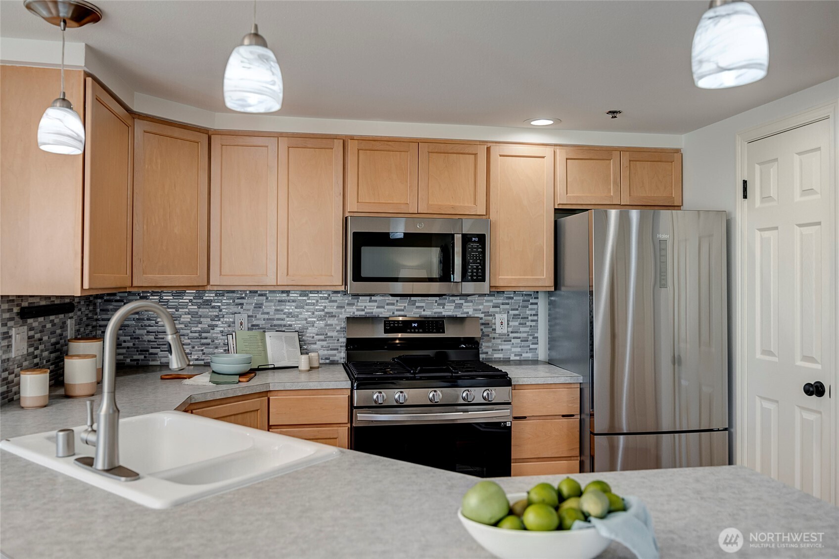 3621 Wallingford Avenue North, Unit 201 Seattle, WA 98103 - Photo 4 of 27 a kitchen with granite countertop a refrigerator stove and sink