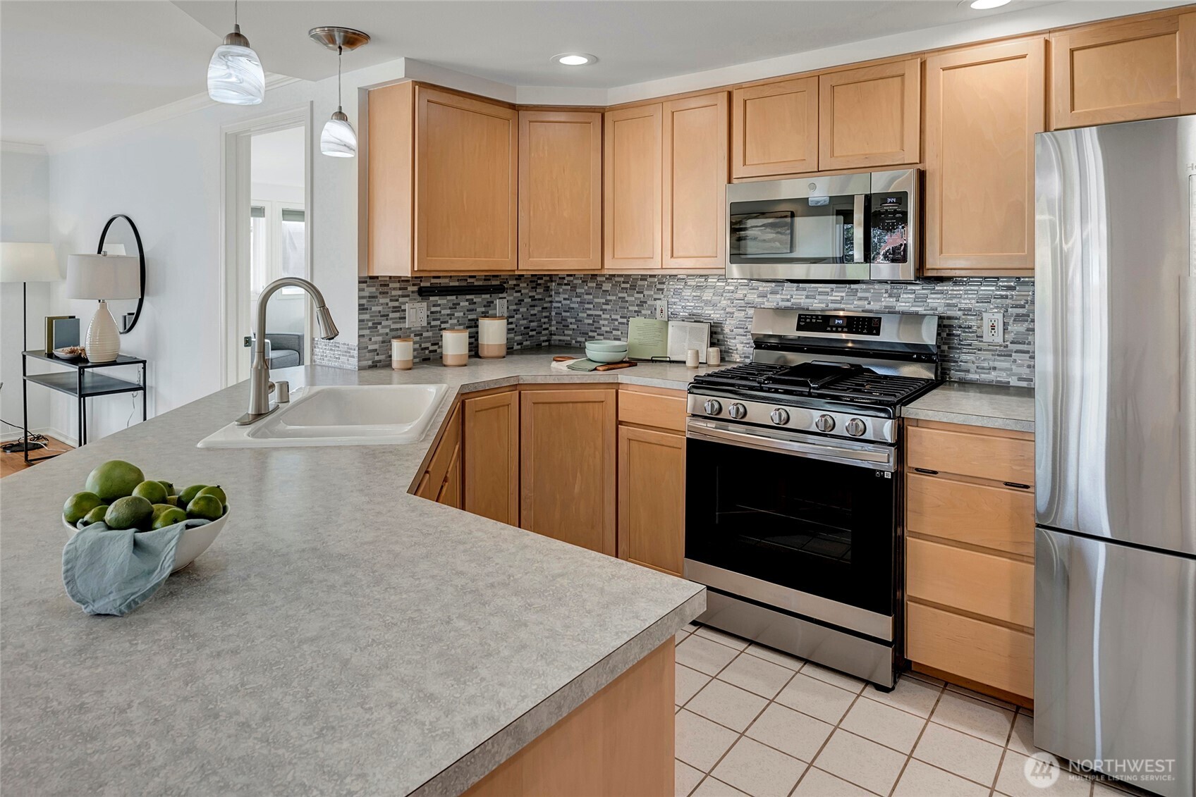 3621 Wallingford Avenue North, Unit 201 Seattle, WA 98103 - Photo 5 of 27 a kitchen with stainless steel appliances granite countertop a stove a sink dishwasher a microwave oven with granite countertops and cabinets