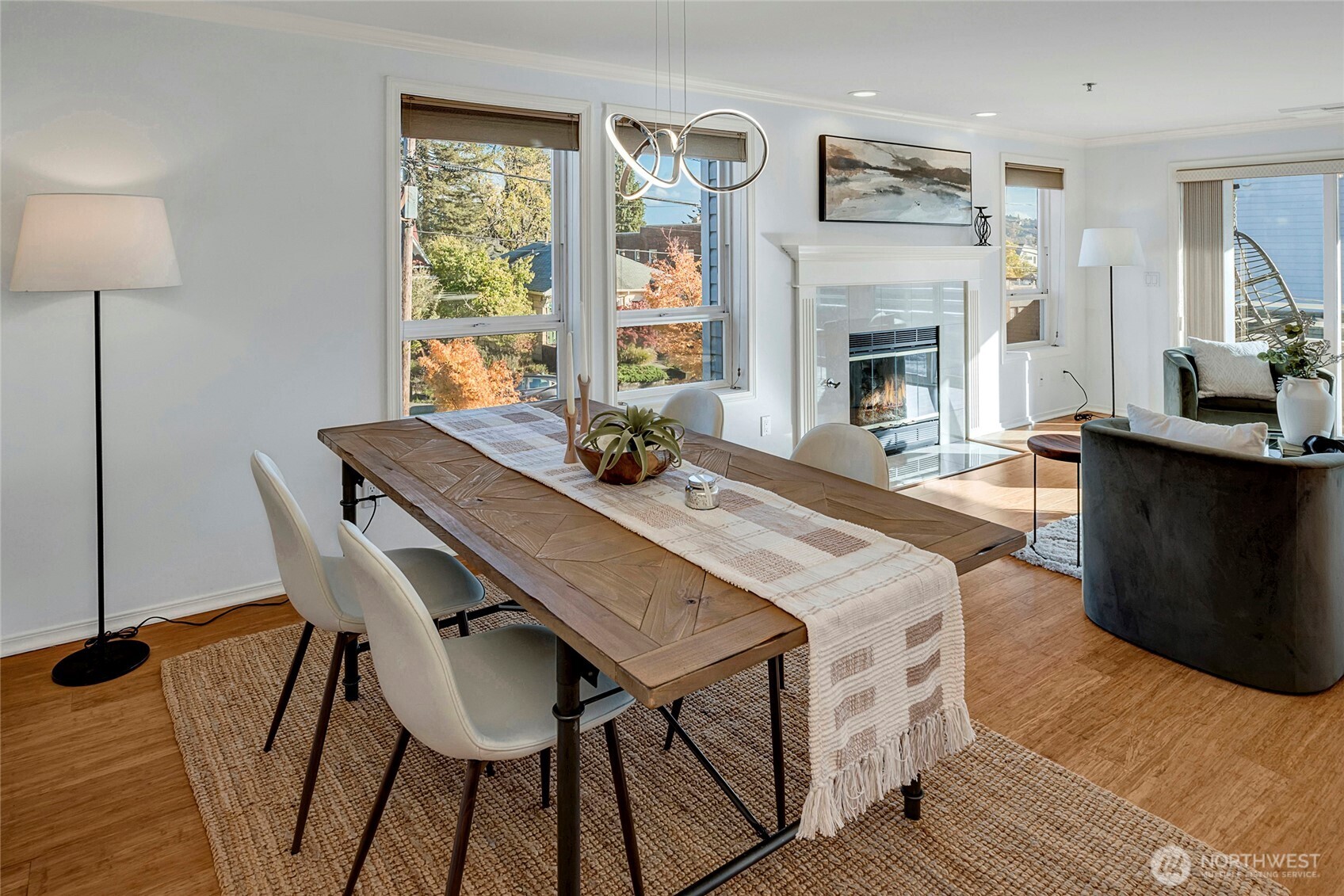 3621 Wallingford Avenue North, Unit 201 Seattle, WA 98103 - Photo 7 of 27 a dining room with furniture a fireplace and wooden floor