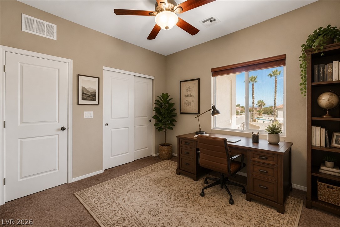 5014 Fiery Sky Ridge Street Las Vegas, NV 89148 - Photo 12 of 21 A well-lit home office features a practical built-in desk and ample storage space.