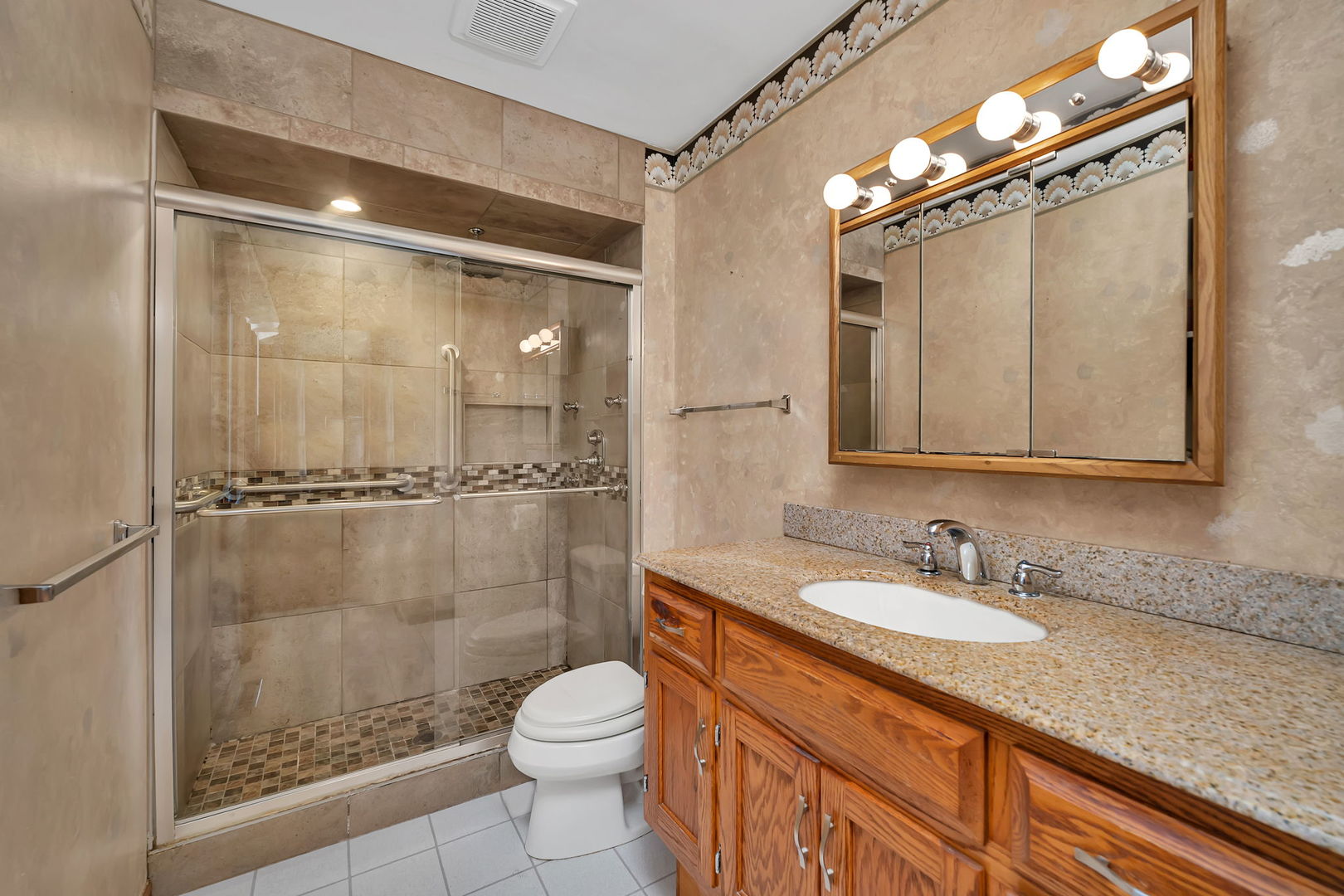214 Deerpath Drive Minooka, IL 60447 - Photo 16 of 25 a bathroom with a granite countertop sink a mirror and a shower