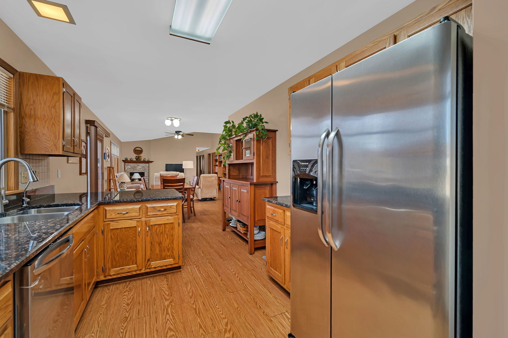 214 Deerpath Drive Minooka, IL 60447 - Photo 8 of 25 a kitchen with stainless steel appliances granite countertop a refrigerator a stove and a sink with granite countertops