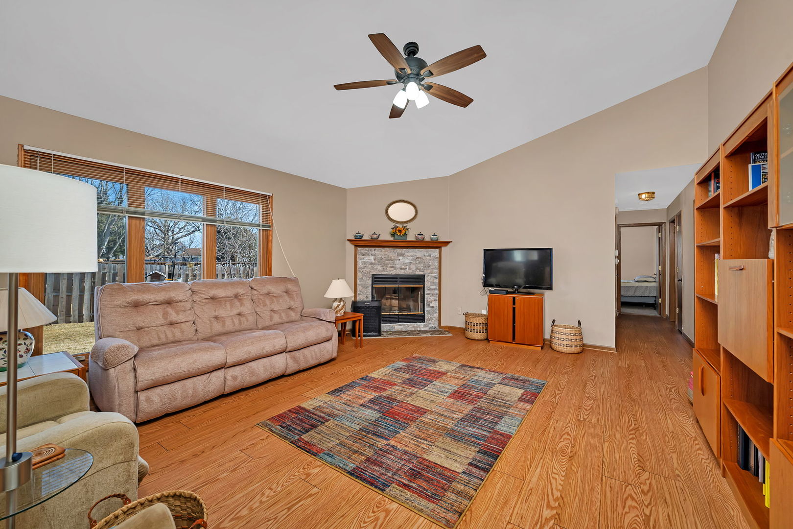 214 Deerpath Drive Minooka, IL 60447 - Photo 10 of 25 a living room with furniture a fireplace and a flat screen tv