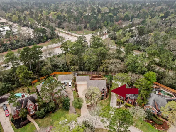 an aerial view of a house with a yard and lake view