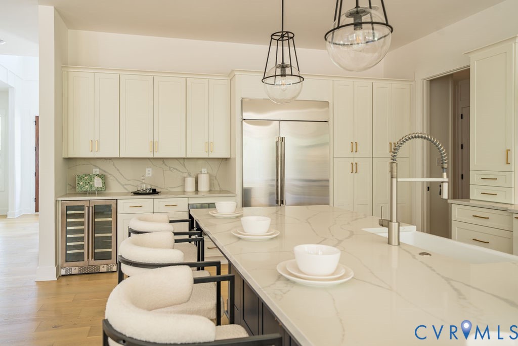 1175 Cardinal Crest Terrace Midlothian, VA 23113 - Photo 11 of 50 a kitchen with stainless steel appliances kitchen island granite countertop a table and chairs in it