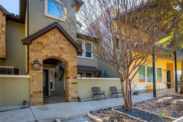 a front view of a house with trees