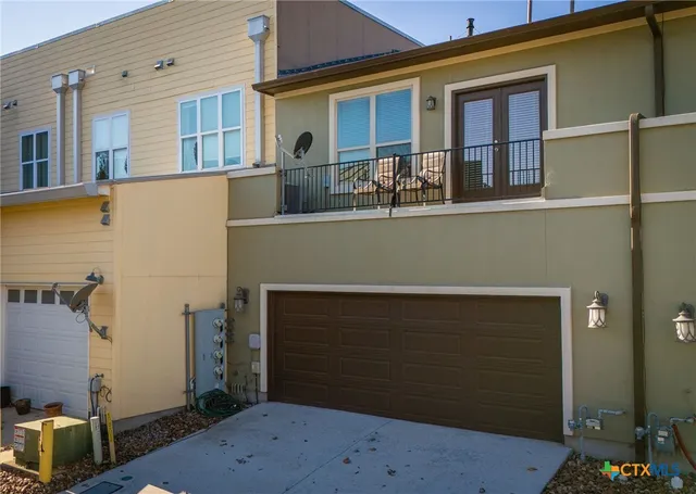 a front view of a house with large windows