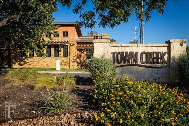 a view of a street with potted plants