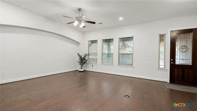 wooden floor in an empty room with a window