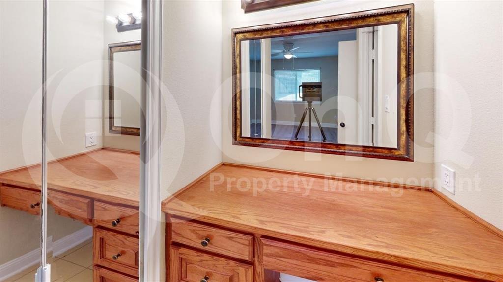 3005 Meandering Way Bedford, TX 76021 - Photo 8 of 24 Integrated vanity with wood-finish cabinetry and matching countertop