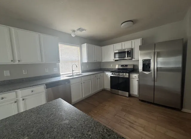 a kitchen with a refrigerator sink and microwave