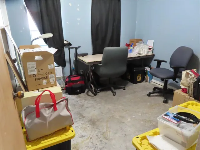 a living room with furniture and a toilet