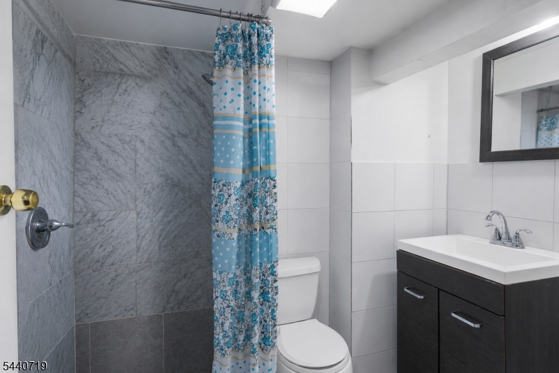 136 Smith Street Elizabeth, NJ 07201 - Photo 34 of 38 a bathroom with a sink toilet and shower