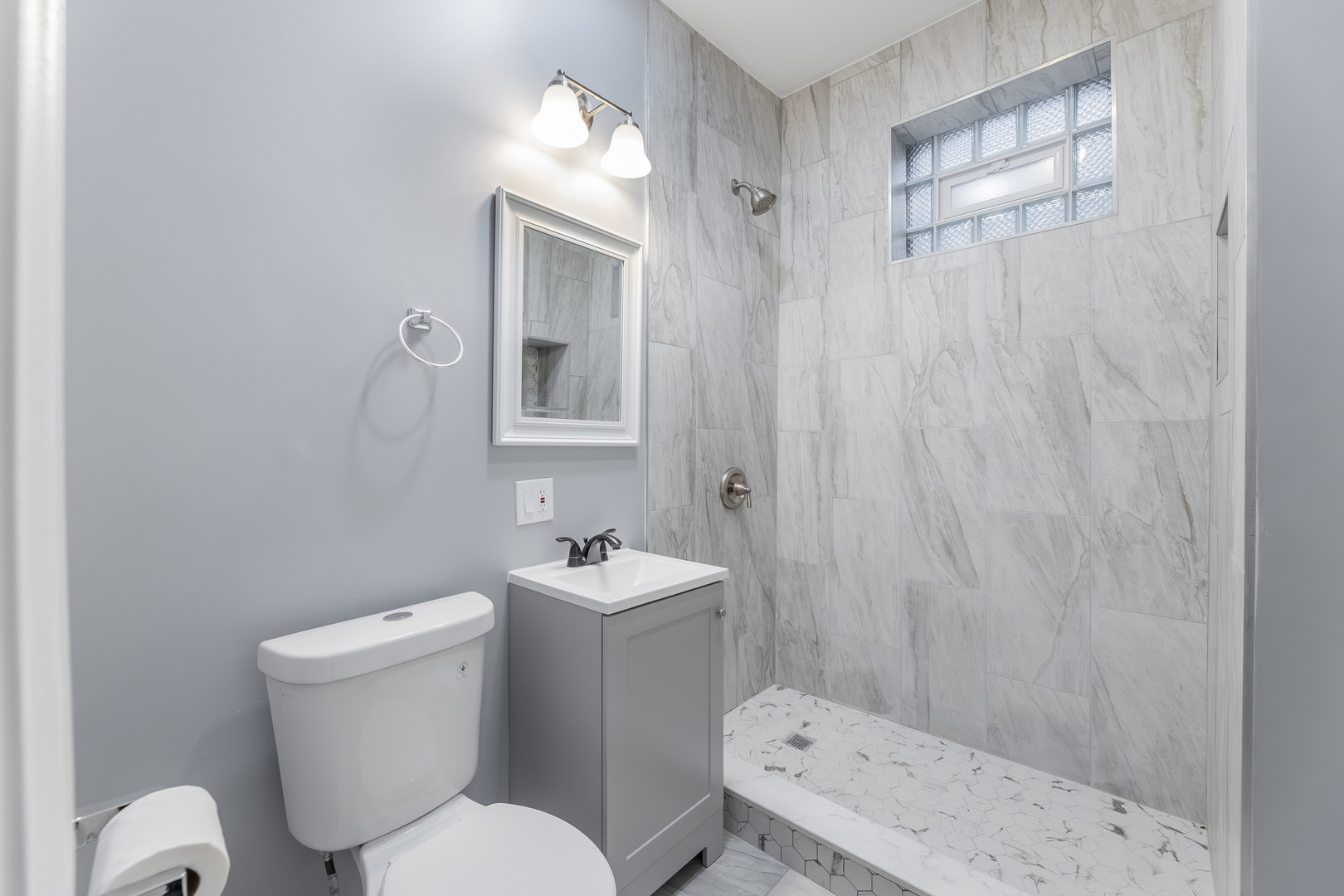 3821 West Fillmore Street, Unit 2B Chicago, IL 60624 - Photo 9 of 11 a white toilet sitting next to a bathroom sink
