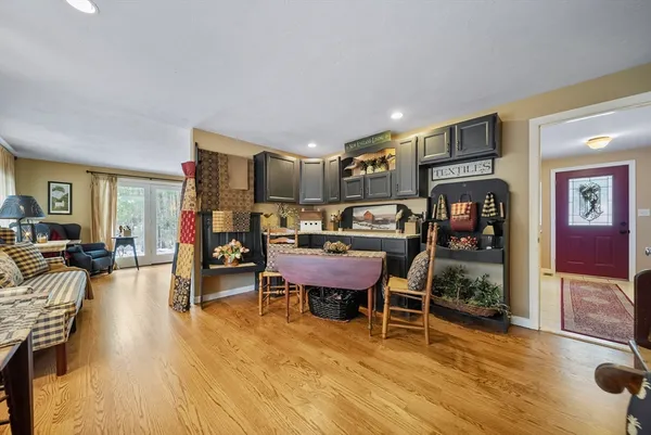 a dining room with furniture and wooden floor