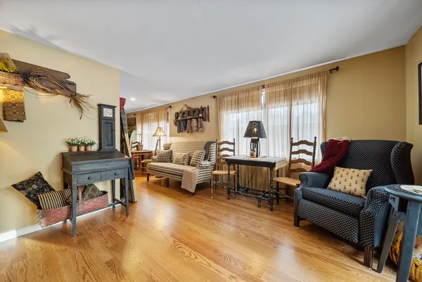 a bedroom with a bed and dresser with mirror