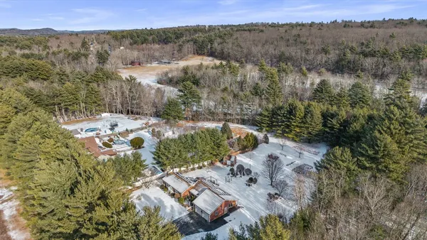 an aerial view of a house with a mountain