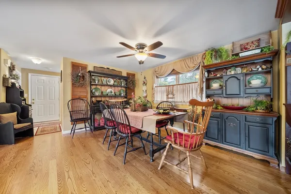 a view of a dining room with furniture window and wooden floor