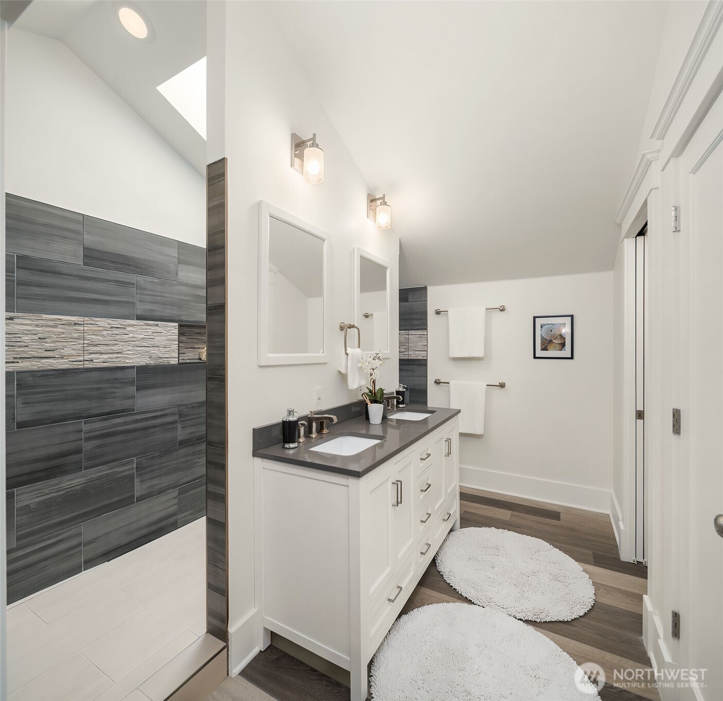 519 27th Avenue Seattle, WA 98122 - Photo 19 of 38 a bathroom with a granite countertop sink a toilet a mirror and shower