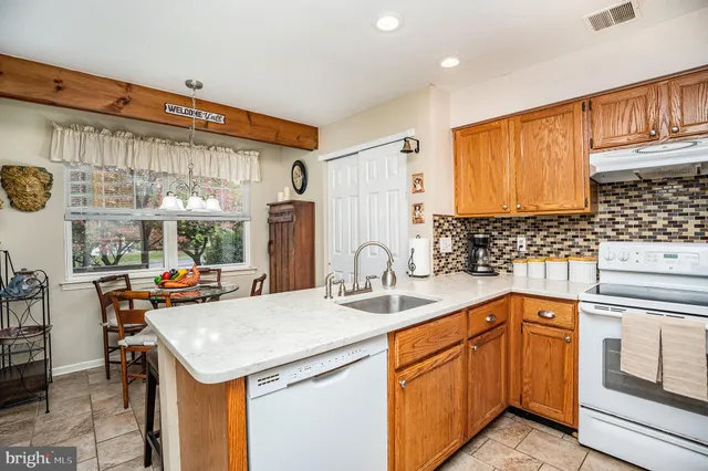 a kitchen with stainless steel appliances granite countertop a sink and cabinets