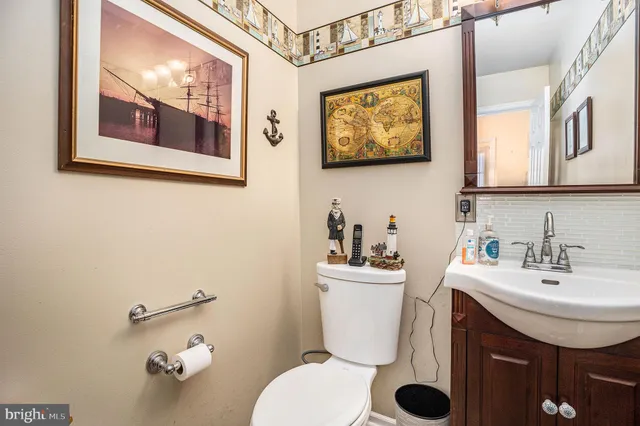 a bathroom with a toilet a sink and mirror