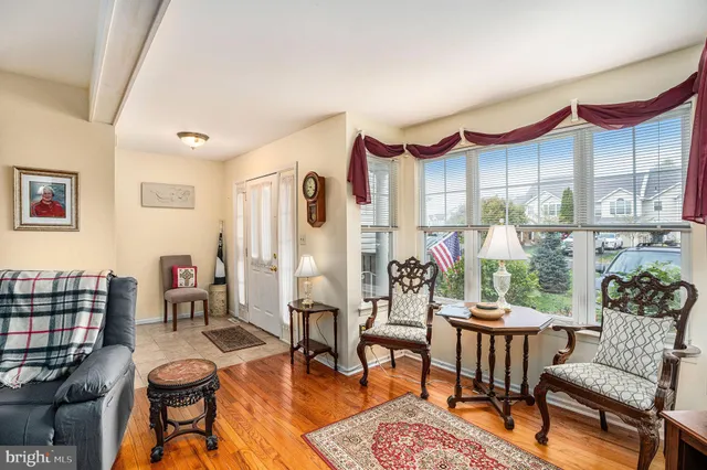 a living room with furniture a rug and a table