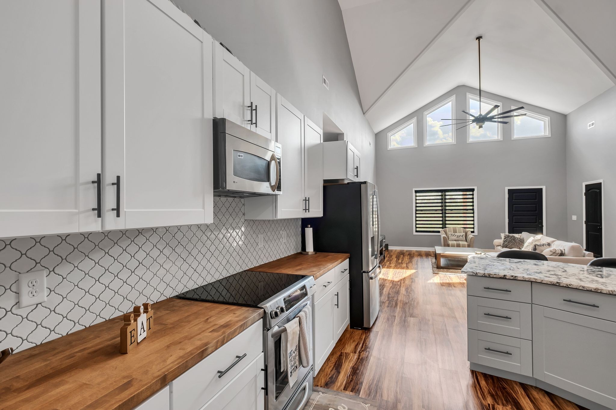 310 Christopher Lane Lawrenceburg, TN 38464 - Photo 12 of 50 a kitchen with stainless steel appliances granite countertop a sink stove and refrigerator